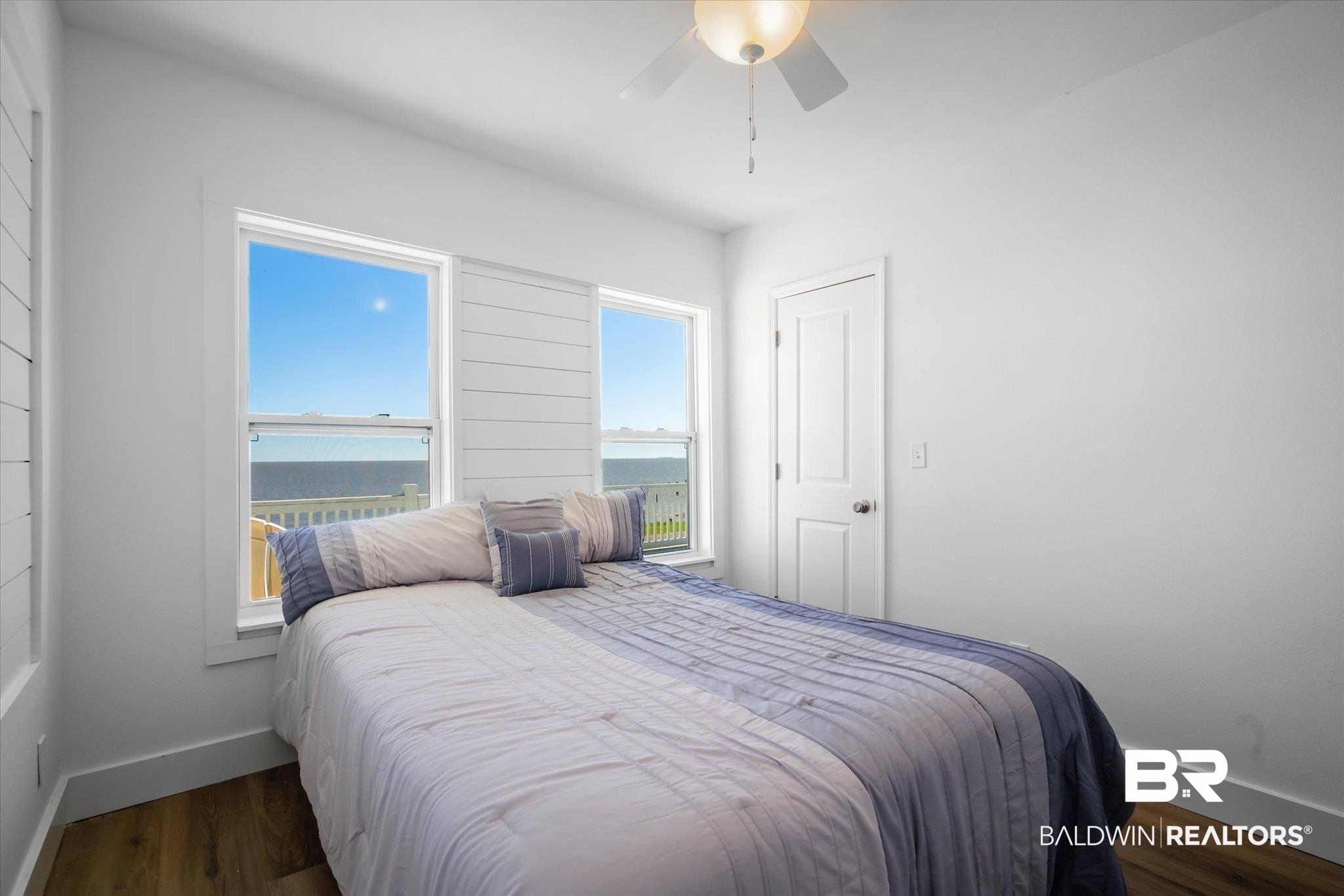 15111 Regus Road Coden, AL 36523 - Photo 14 of 35 Bedroom with a water view, dark wood-style floors, and a ceiling fan