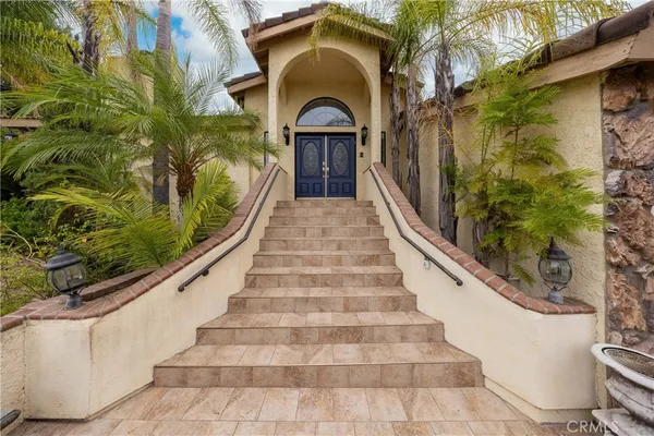 a view of a house with a swimming pool and a large tree