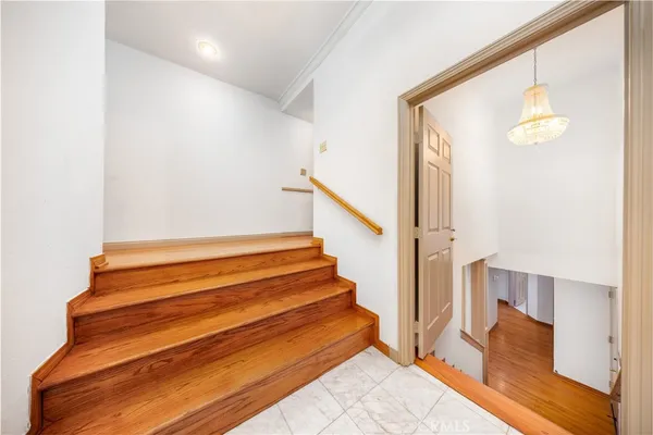 a view of a big room with wooden floor and windows