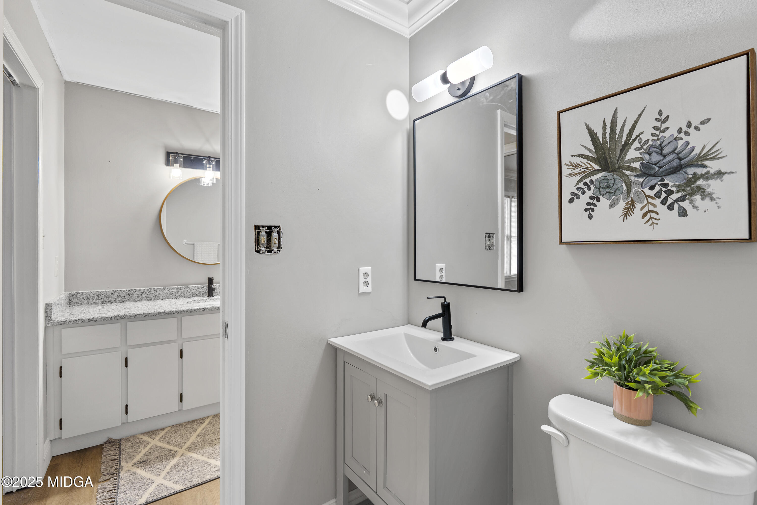 218 Matlock Lane Macon, GA 31210 - Photo 31 of 39 a bathroom with a toilet sink and mirror
