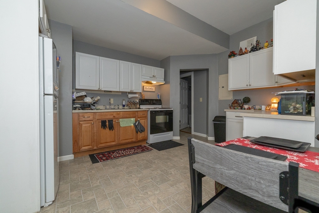 35 May Street Worcester, MA 01610 - Photo 18 of 30 a kitchen with refrigerator stove and cabinets