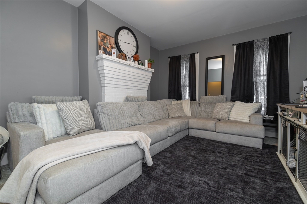 35 May Street Worcester, MA 01610 - Photo 23 of 30 a living room with furniture or couch and a mirror