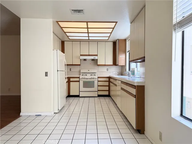 a kitchen with stainless steel appliances a sink and a refrigerator