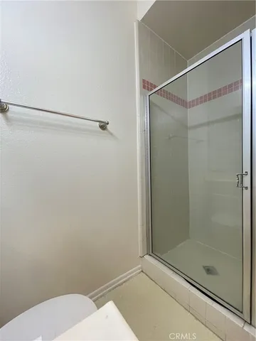 a bathroom with a shower and a toilet