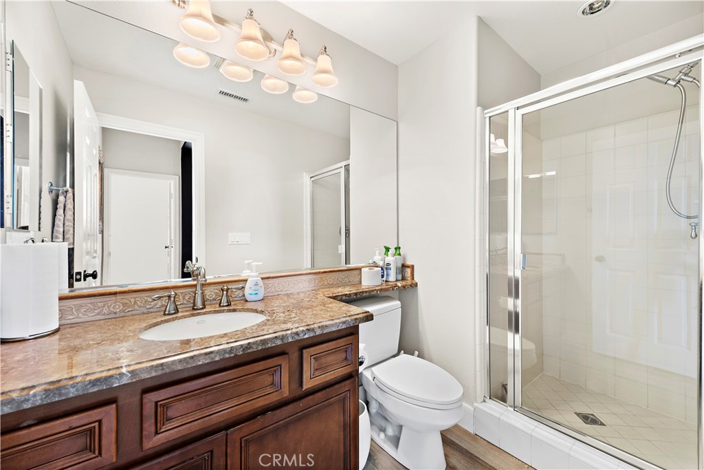 1412 Manera Ventosa San Clemente, CA 92673 - Photo 14 of 21 a bathroom with a granite countertop sink toilet a mirror and shower