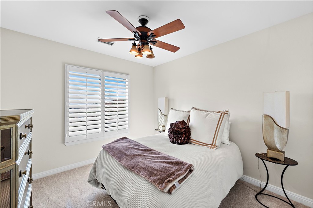 1412 Manera Ventosa San Clemente, CA 92673 - Photo 15 of 21 a bedroom with a bed and a chandelier