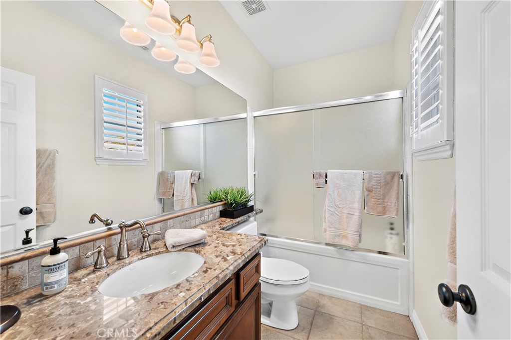 1412 Manera Ventosa San Clemente, CA 92673 - Photo 19 of 21 a bathroom with a granite countertop sink a toilet and shower