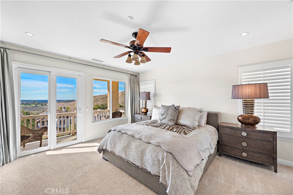1412 Manera Ventosa San Clemente, CA 92673 - Photo 8 of 21 a bedroom with a large bed and a large window