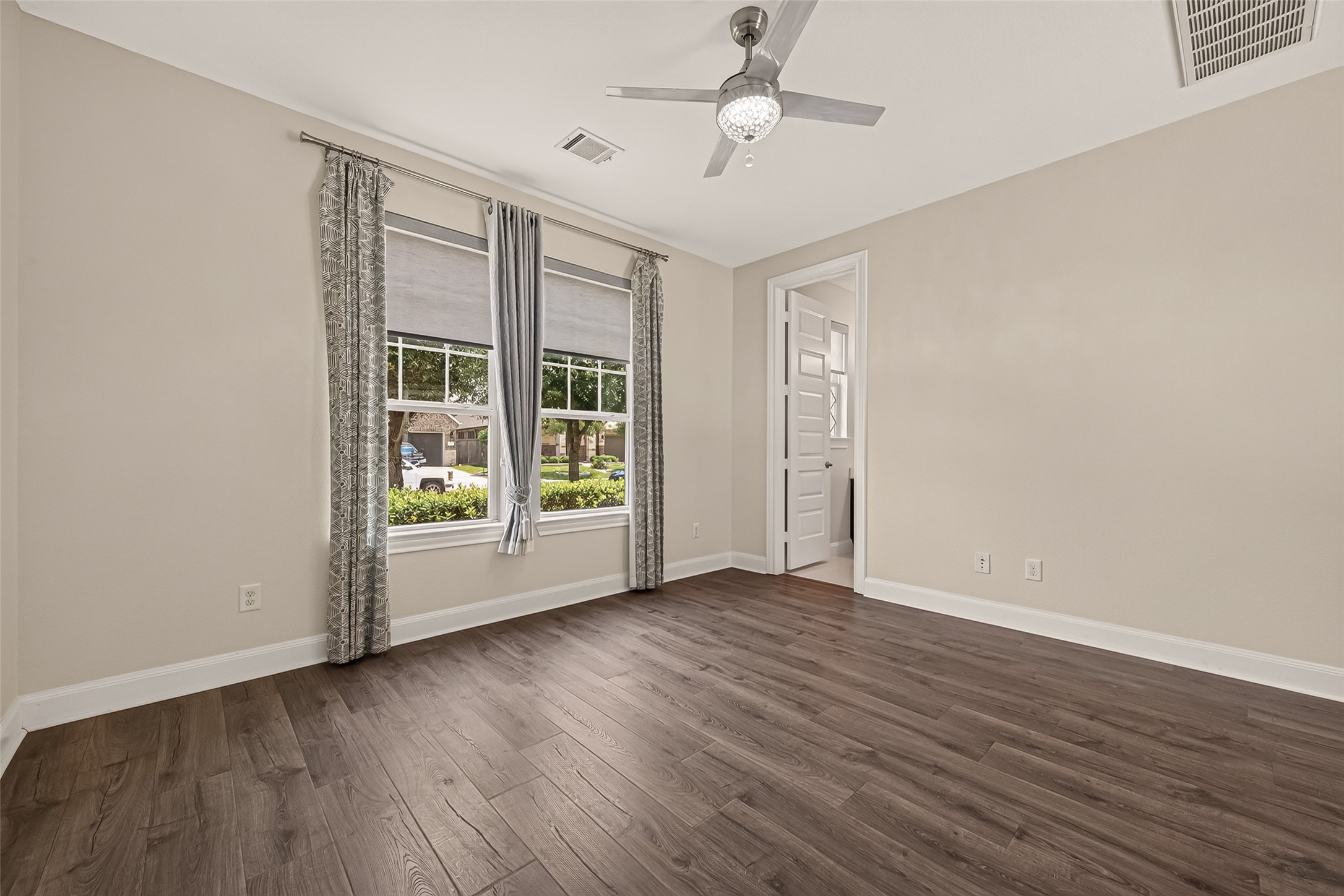 51 Scepter Ridge Sugar Land, TX 77498 - Photo 4 of 48 The 1st floor secondary bedroom is located at the front of the home and is complete with a full bath and a walk-in closet! Imagine this room as a quiet retreat for guests or family. Laminate floors, soft natural light, and a ceiling fan create a comfortable bedroom that feels bright and easy to live in.