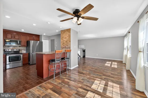 a view of kitchen with furniture and refrigerator