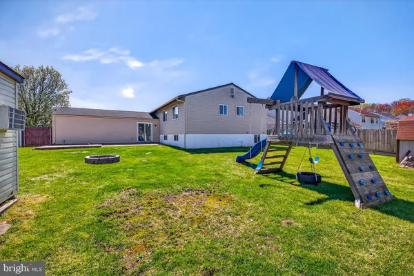 a view of an house with swimming pool and deck