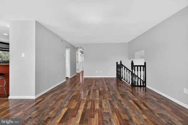 a view of a room with wooden floor and stairs