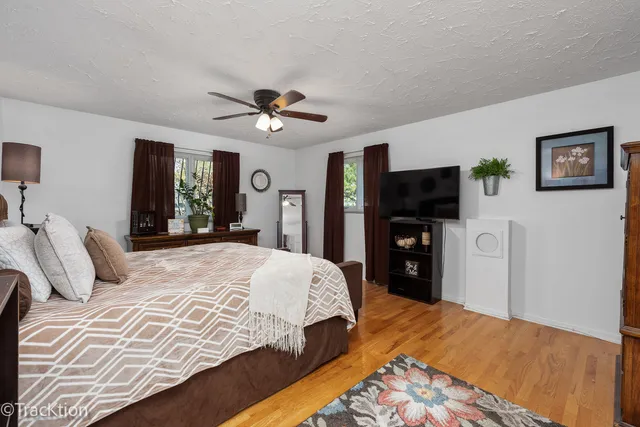 a bedroom with a large bed and a tv