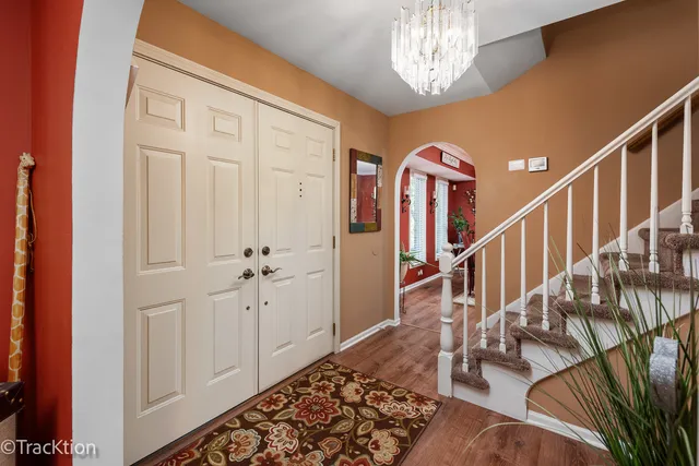 a view of entryway and hall with wooden floor