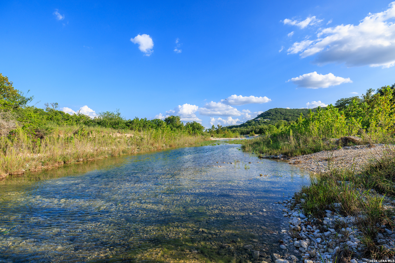0 Rm 336 Leakey, TX 78873 - Photo 37 of 93 a view of a lake with a house in the background