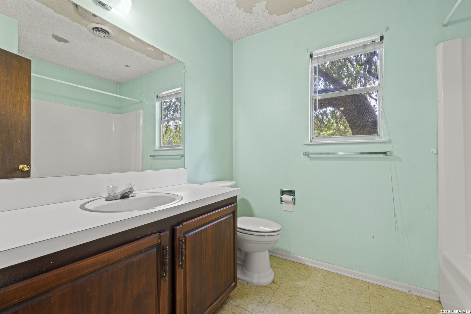 0 Rm 336 Leakey, TX 78873 - Photo 49 of 77 a bathroom with a granite countertop sink and a mirror