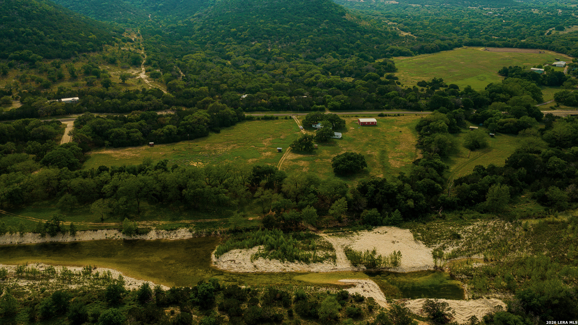 0 Rm 336 Leakey, TX 78873 - Photo 73 of 77 an aerial view of lake residential house with outdoor space and trees all around