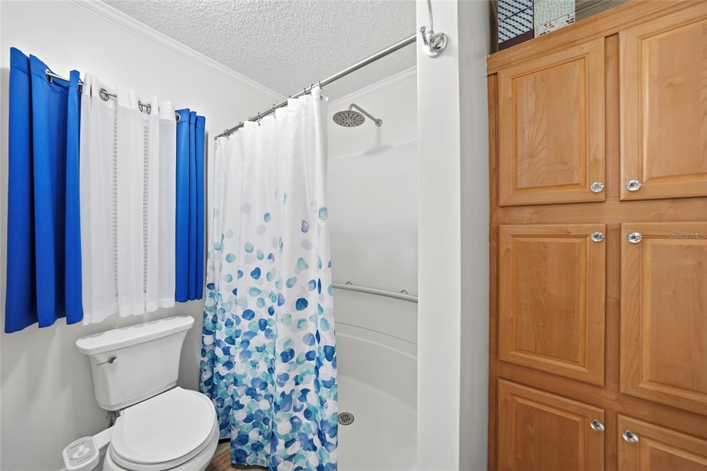 10303 Burnt Store Road, Unit 143 Punta Gorda, FL 33950 - Photo 16 of 42 a white toilet sitting next to a bathroom
