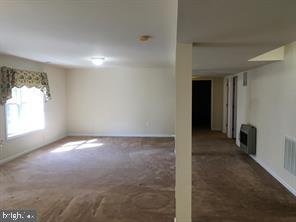 405 Custer Court Berryville, VA 22611 - Photo 18 of 34 an empty room with a empty space and windows