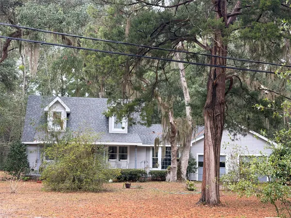a view of a house with a tree in front
