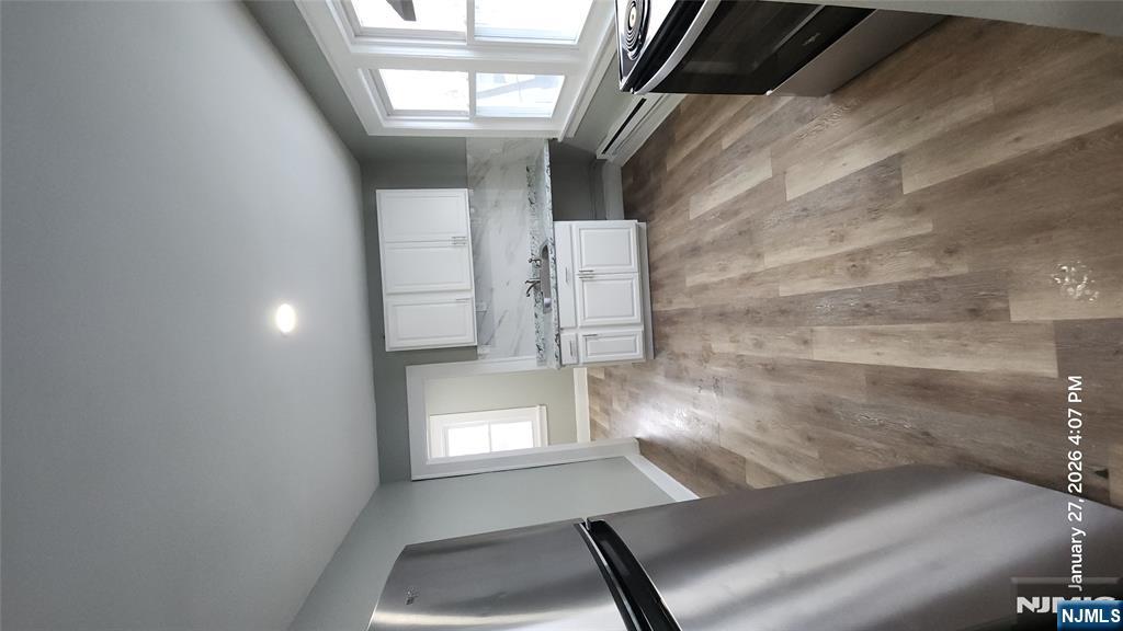 a large kitchen with stainless steel appliances a large counter top and a stove