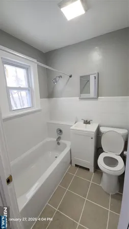 a bathroom with a bathtub toilet and sink