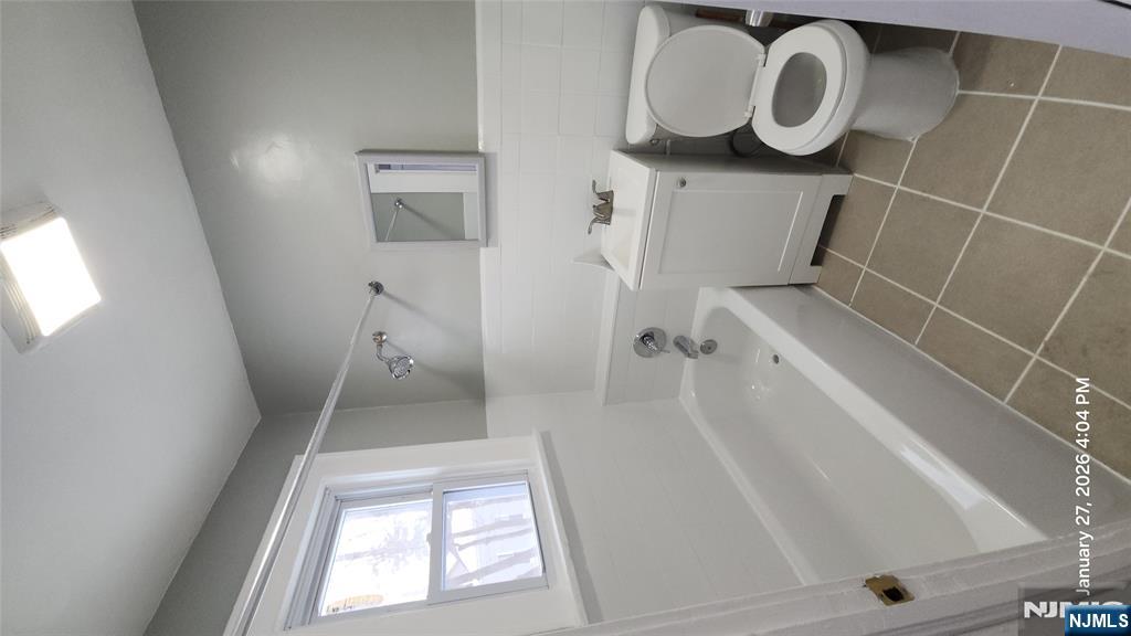 180 Vassar Avenue, Unit 178 Newark, NJ 07112 - Photo 5 of 9 a bathroom with a bathtub toilet and sink