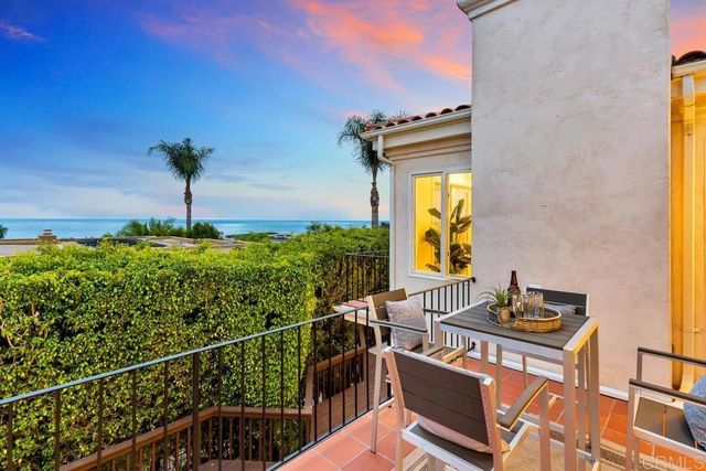a view of a livingroom with furniture and a kitchen view