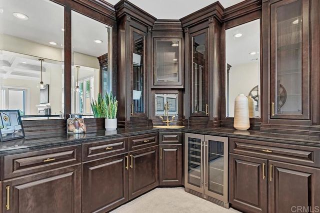 a kitchen with granite countertop a sink stove and cabinets