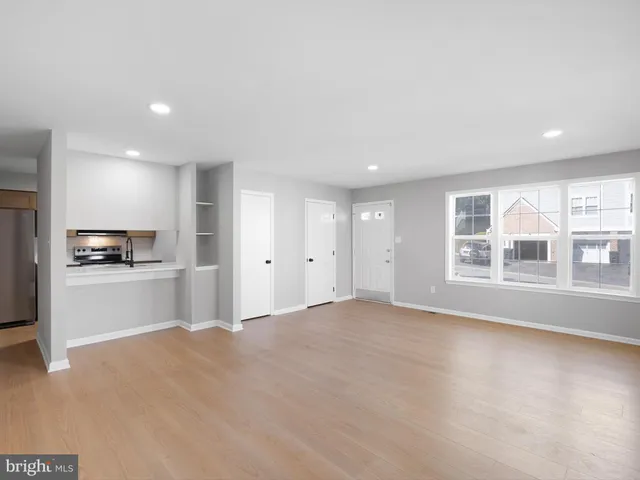 an empty room with windows and closet