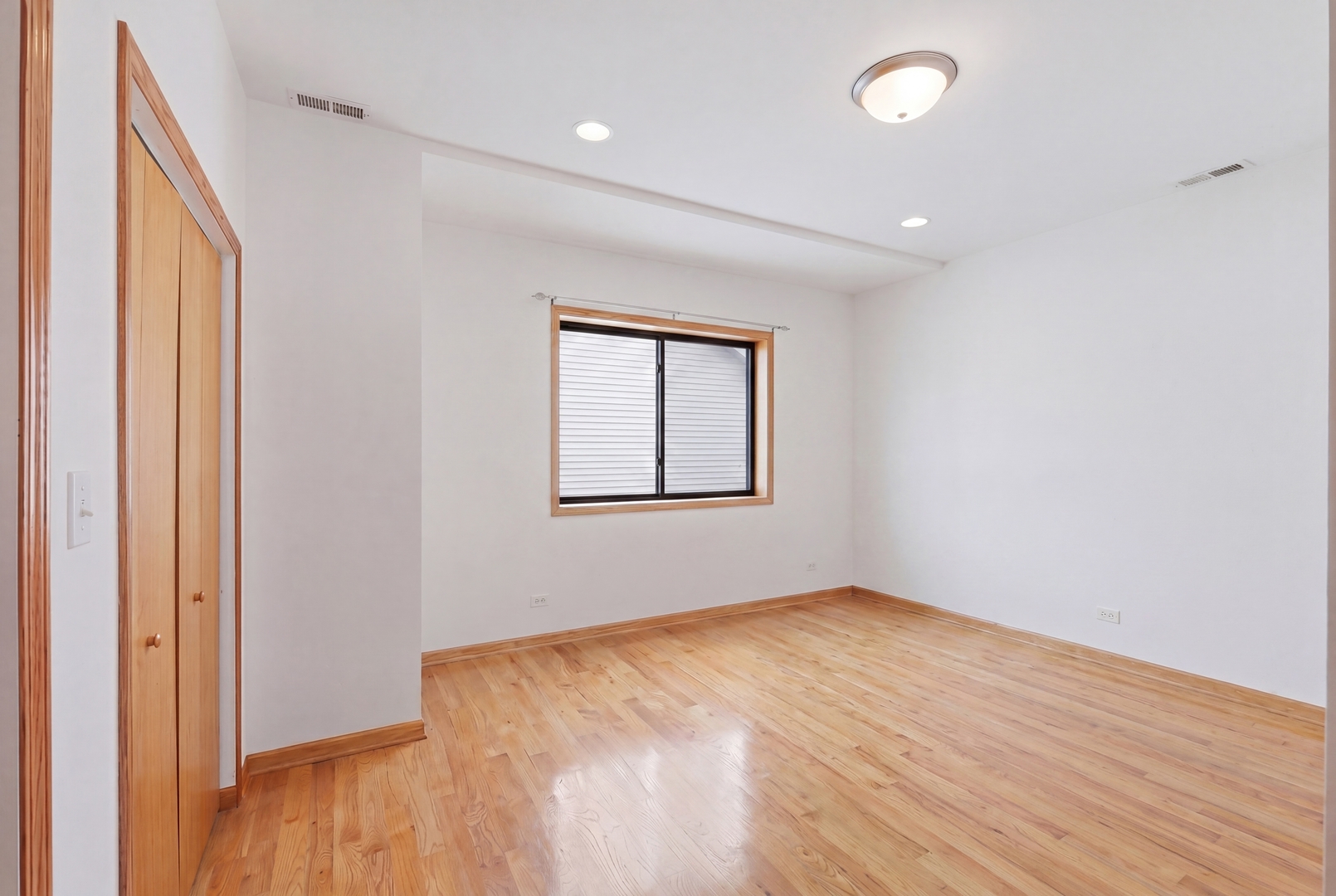 3917 West 60th Street Chicago, IL 60629 - Photo 14 of 34 an empty room with wooden floor and windows