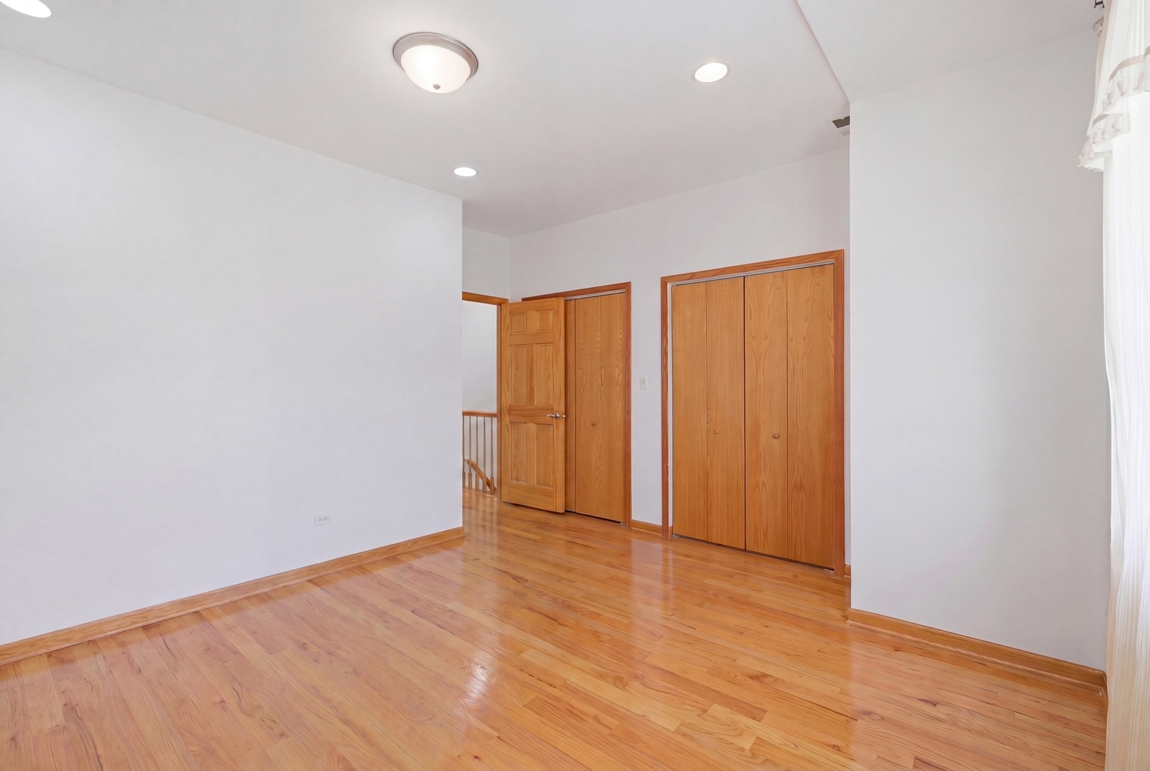 3917 West 60th Street Chicago, IL 60629 - Photo 15 of 34 a view of an empty room with wooden floor and a window