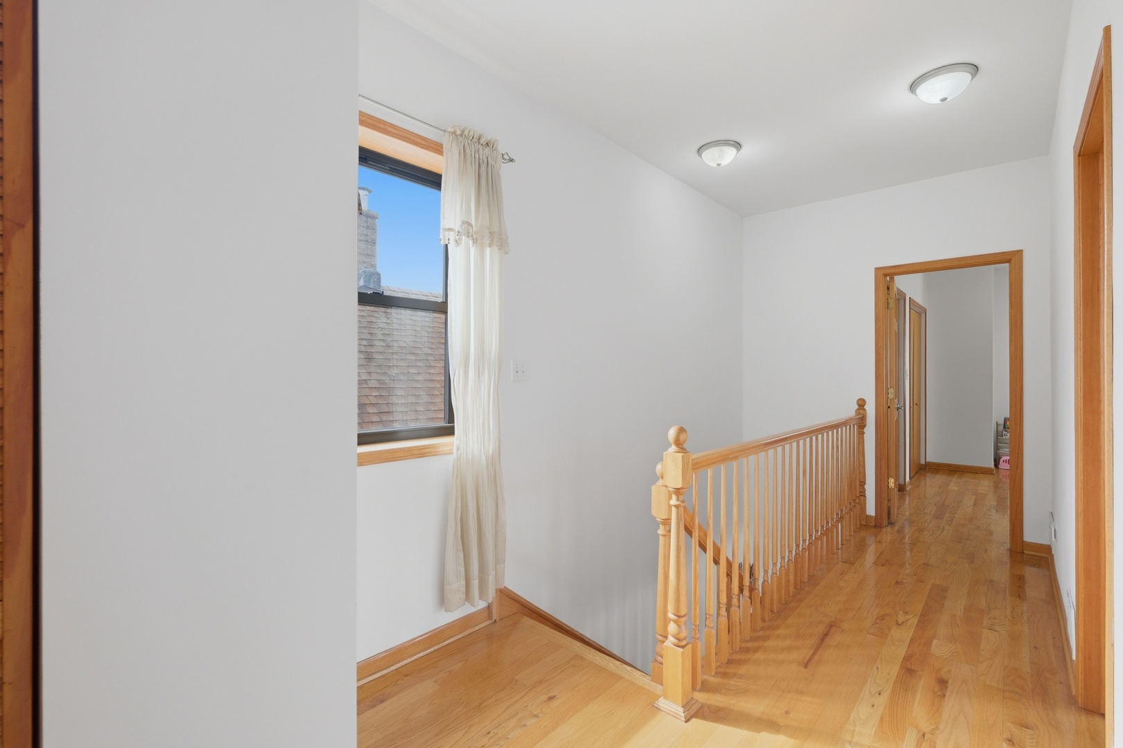 3917 West 60th Street Chicago, IL 60629 - Photo 19 of 34 a view of a hallway with wooden floor and staircase