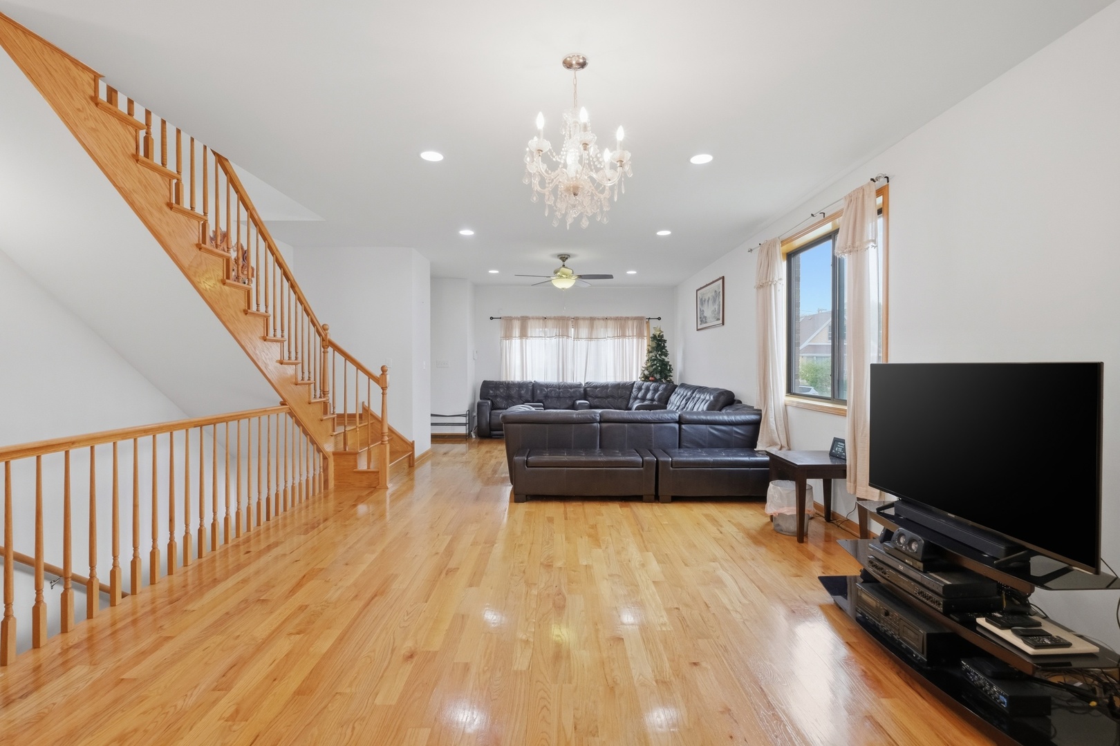 3917 West 60th Street Chicago, IL 60629 - Photo 4 of 34 a living room with a flat screen tv and a dining table