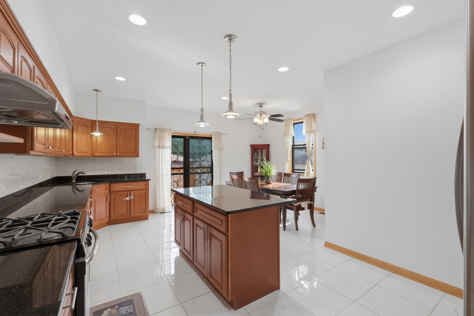 3917 West 60th Street Chicago, IL 60629 - Photo 6 of 34 a kitchen with stainless steel appliances granite countertop a stove a sink and a refrigerator