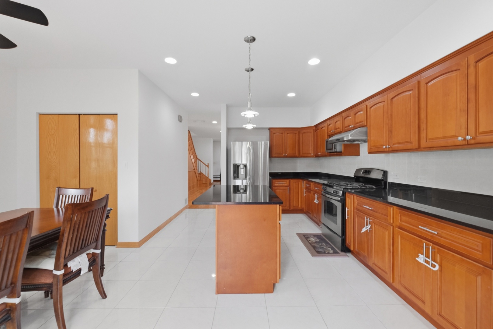 3917 West 60th Street Chicago, IL 60629 - Photo 8 of 34 a large kitchen with stainless steel appliances kitchen island granite countertop a large counter top space and a refrigerator