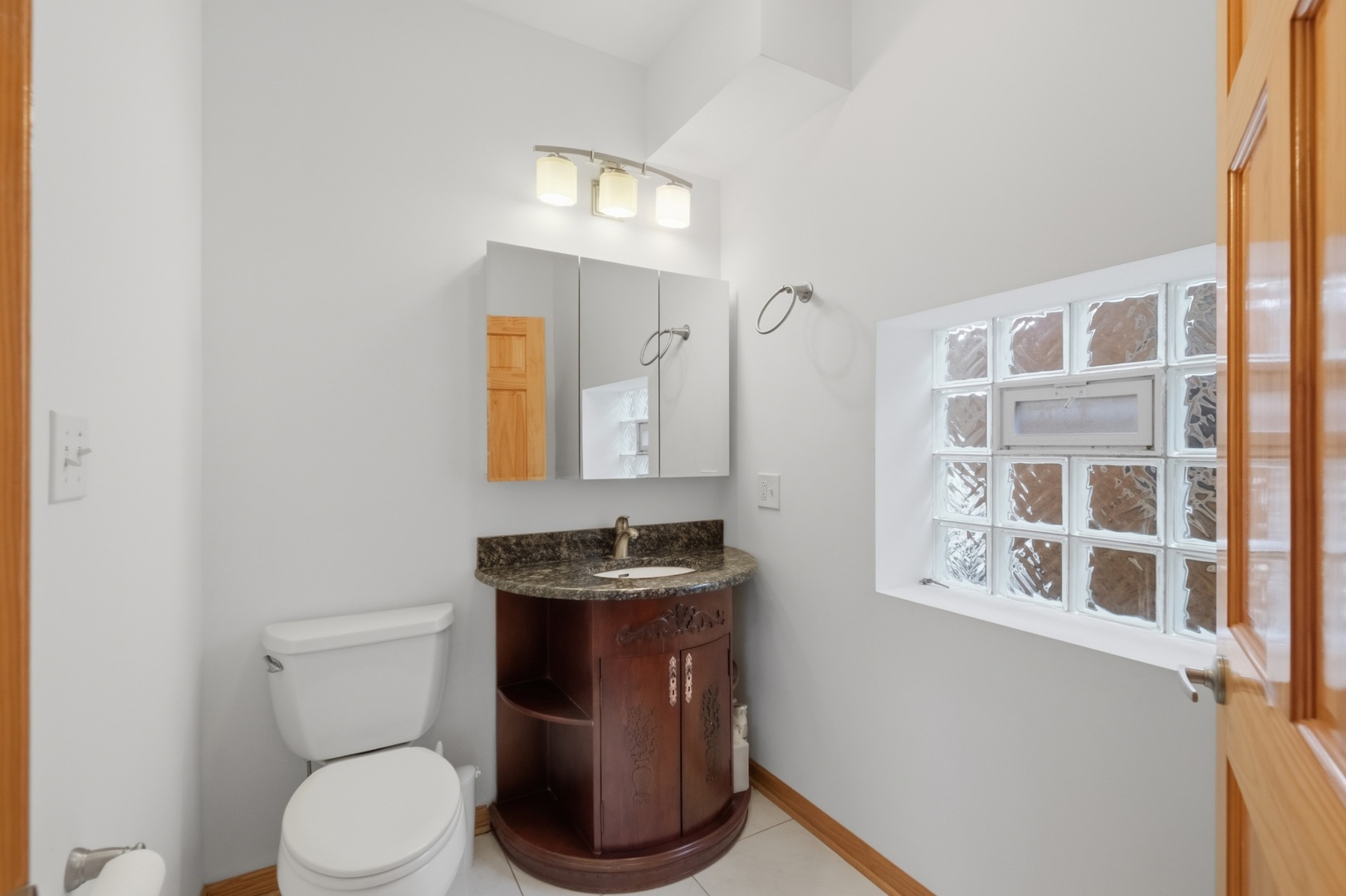 3917 West 60th Street Chicago, IL 60629 - Photo 10 of 34 a bathroom with a toilet sink and mirror