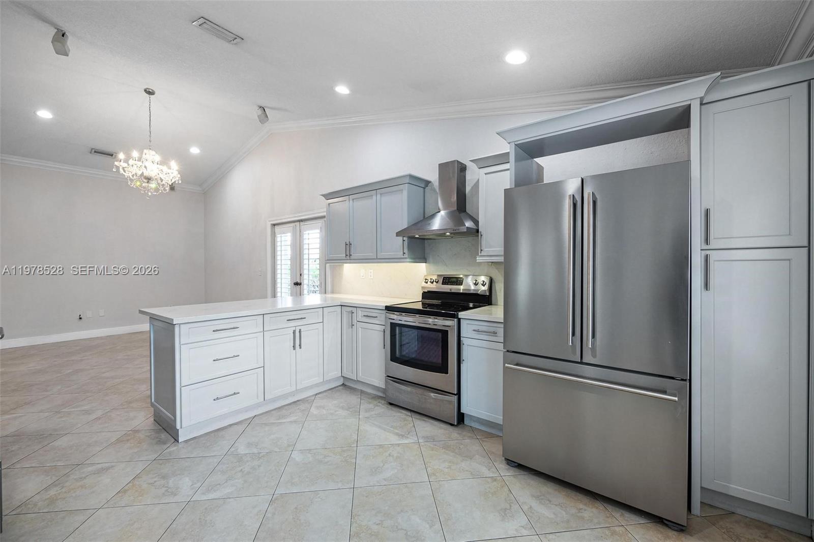 15327 Southwest 55th Terrace Miami, FL 33185 - Photo 17 of 40 a kitchen with a refrigerator and a sink