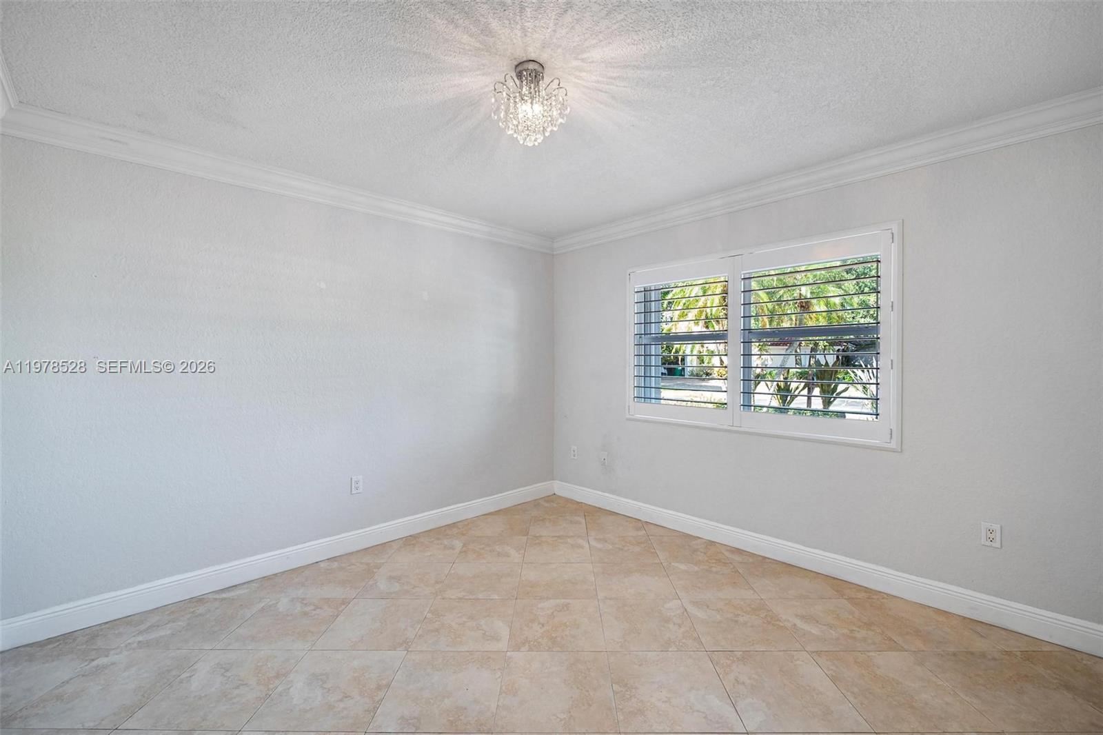 15327 Southwest 55th Terrace Miami, FL 33185 - Photo 23 of 40 an empty room with a window and a fan