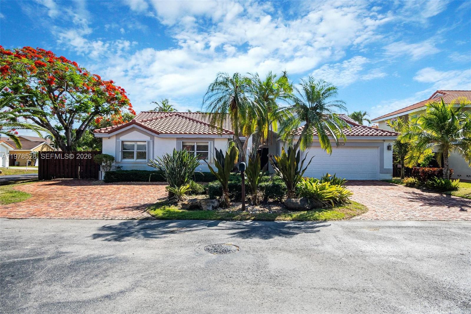 15327 Southwest 55th Terrace Miami, FL 33185 - Photo 3 of 40 a front view of a house with a yard and a garage