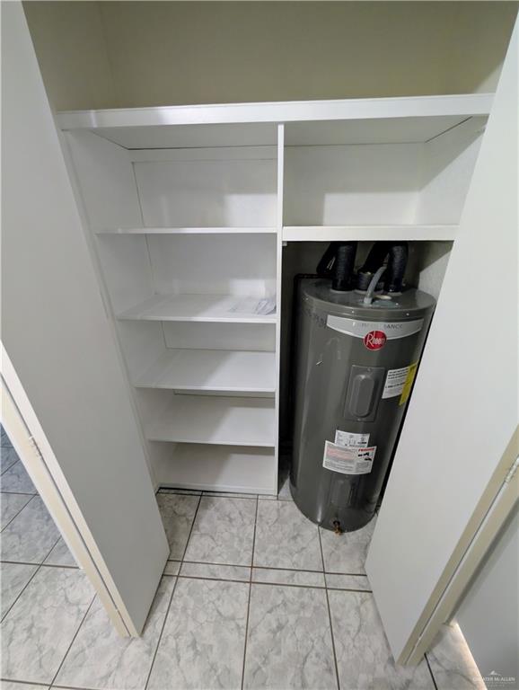807 East 21st Street, Unit 2 Mission, TX 78572 - Photo 15 of 16 Utility room featuring water heater and sholving