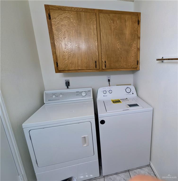 807 East 21st Street, Unit 2 Mission, TX 78572 - Photo 16 of 16 Laundry area with cabinet space, washer and dryer, located in primary bathroom