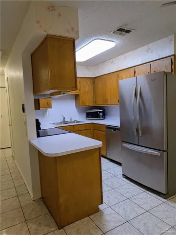 a kitchen with stainless steel appliances a sink and a refrigerator