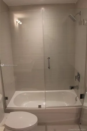 a bathroom with a shower and a toilet