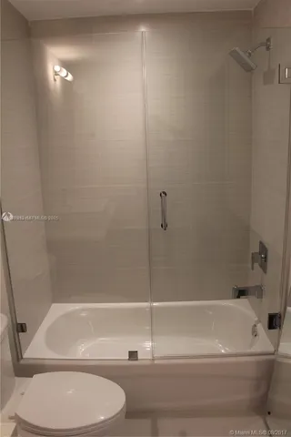 a bathroom with a shower and a toilet