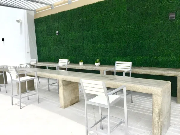 a view of an chairs and tables in the back yard