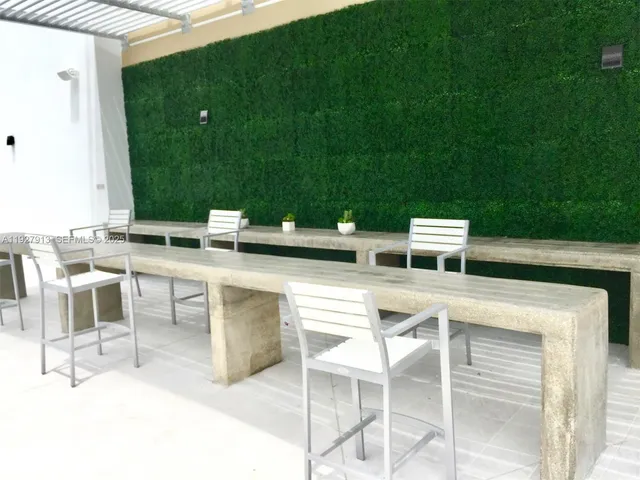 a view of an chairs and tables in the back yard