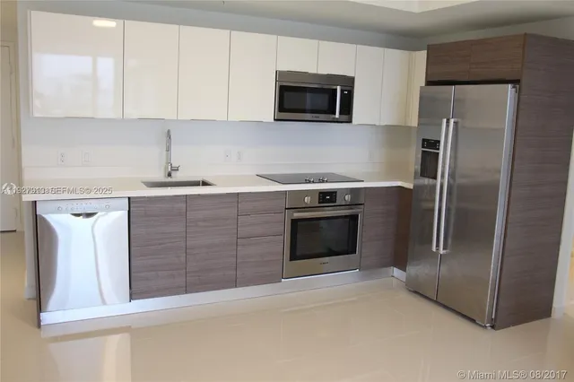 a kitchen with granite countertop a stove microwave and refrigerator