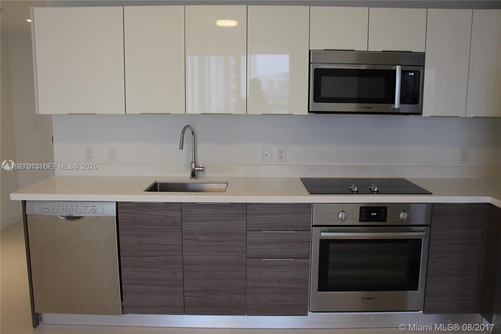 1010 Southwest 2nd Avenue, Unit 810 Miami, FL 33130 - Photo 6 of 23 a kitchen with a stove and a microwave