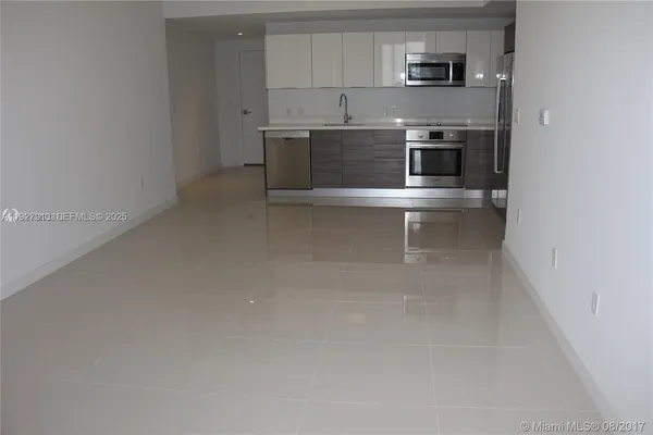 a kitchen with a sink cabinets and stainless steel appliances